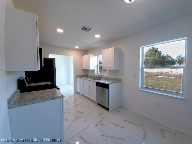 kitchen with electric stove, white cabinetry, sink, and stainless steel dishwasher