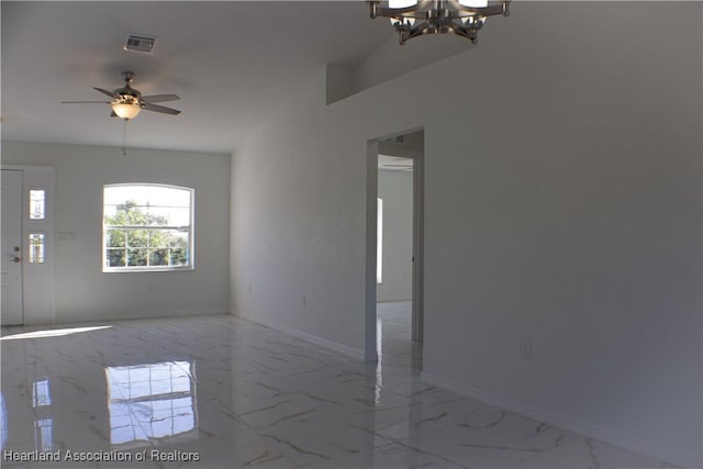 unfurnished room with ceiling fan with notable chandelier