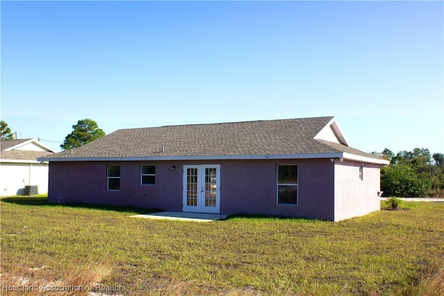 back of property featuring a yard, central air condition unit, and french doors