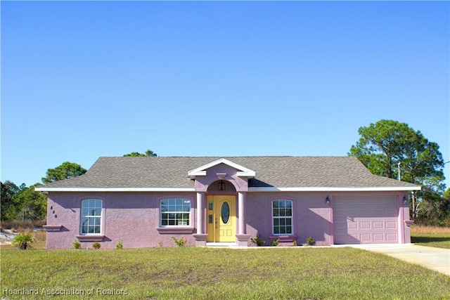 ranch-style house featuring a front lawn and a garage