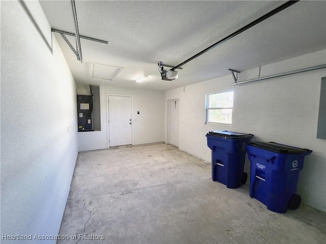 garage featuring electric panel and a garage door opener