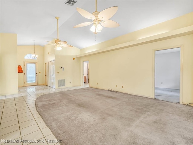 unfurnished living room with ceiling fan, high vaulted ceiling, and light carpet