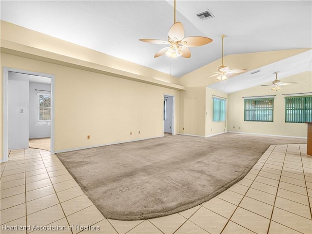 unfurnished room featuring vaulted ceiling, light colored carpet, and ceiling fan