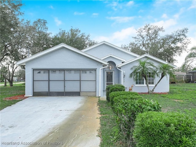 single story home with a garage and a front lawn