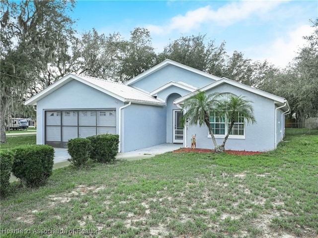 ranch-style home with a garage and a front yard