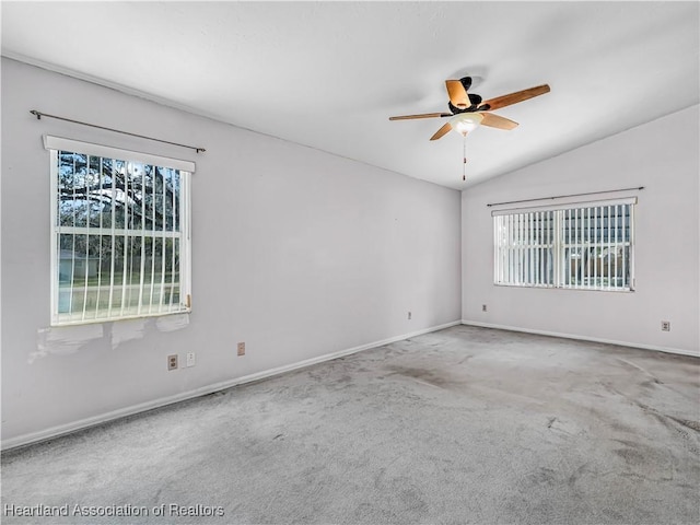 carpeted empty room with ceiling fan and vaulted ceiling