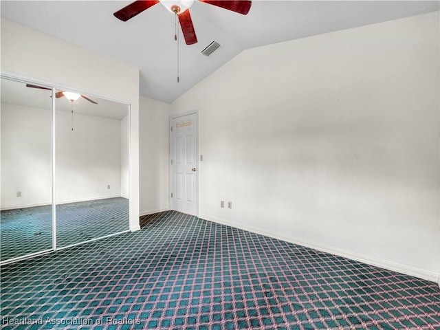 spare room featuring carpet, lofted ceiling, and ceiling fan