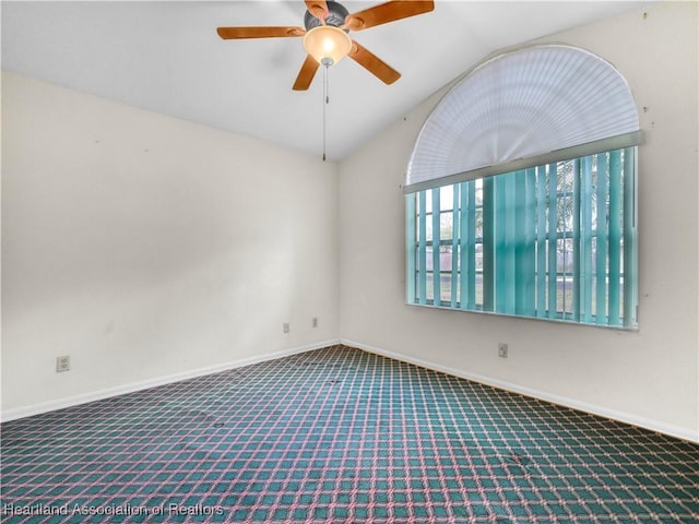 carpeted spare room featuring lofted ceiling and ceiling fan