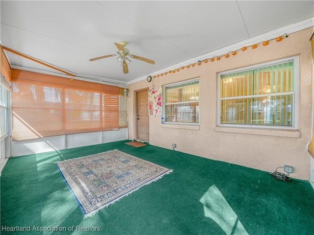 interior space with ceiling fan