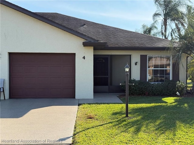 single story home with a garage and a front lawn