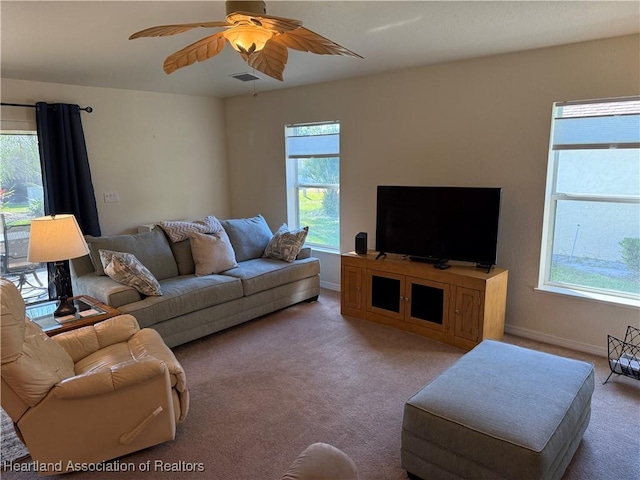 carpeted living room featuring plenty of natural light and ceiling fan