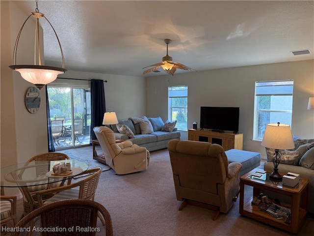 carpeted living room featuring ceiling fan