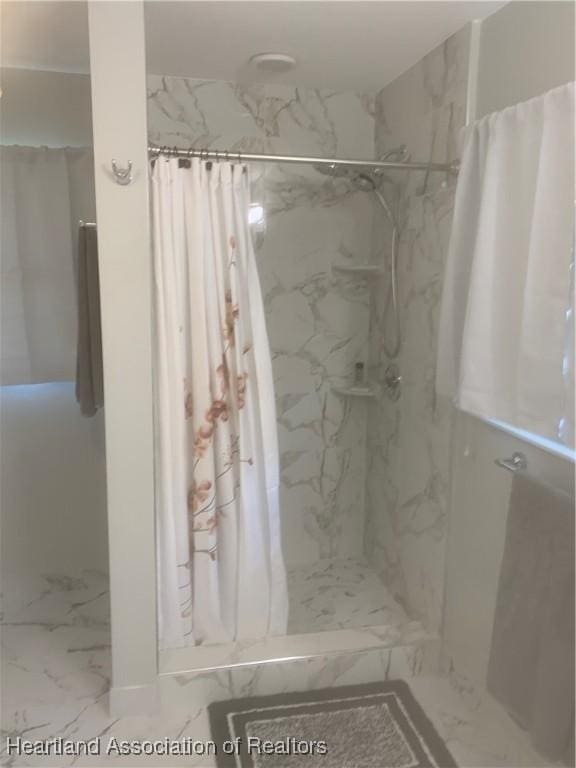 bathroom featuring marble finish floor and a marble finish shower