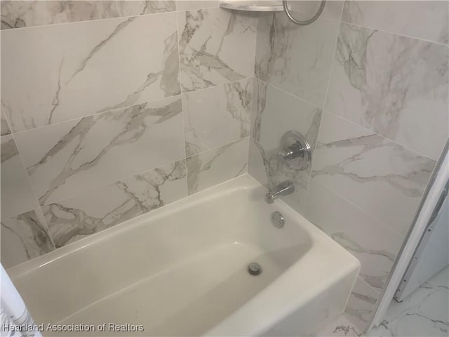 full bathroom with marble finish floor and shower / bathing tub combination