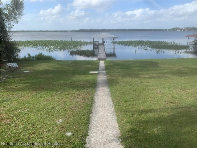 dock area featuring a water view and a yard