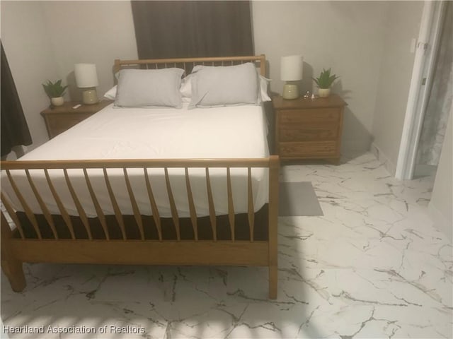 bedroom featuring marble finish floor