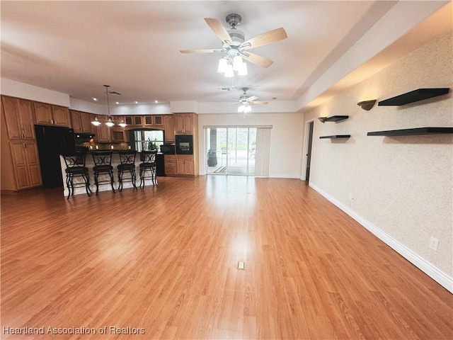 5717 Longbow Dr, Sebring, FL 33876 - living room featuring light wood-style flooring and a ceiling fan