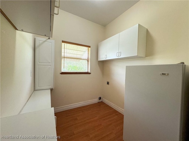 5717 Longbow Dr, Sebring, FL 33876 - laundry room with hookup for an electric dryer, cabinet space, and wood finished floors