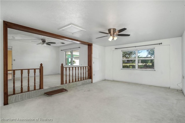 carpeted empty room with a textured ceiling and ceiling fan