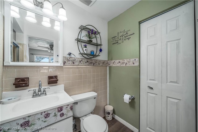 bathroom with hardwood / wood-style floors, vanity, and toilet