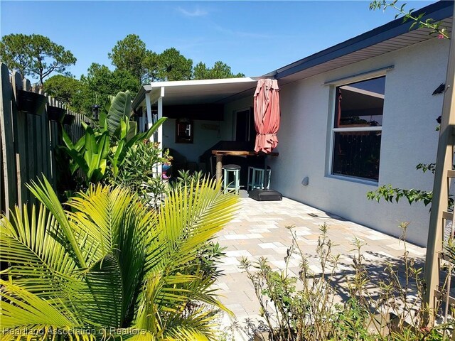 6401 Matanzas Dr, Sebring, FL 33872 - back of house featuring stucco siding, fence, and a patio