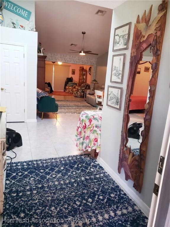 6401 Matanzas Dr, Sebring, FL 33872 - corridor with tile patterned flooring and baseboards