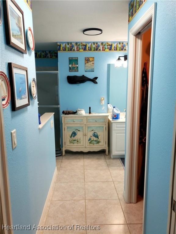 6401 Matanzas Dr, Sebring, FL 33872 - bathroom with tile patterned floors, vanity, and an enclosed shower