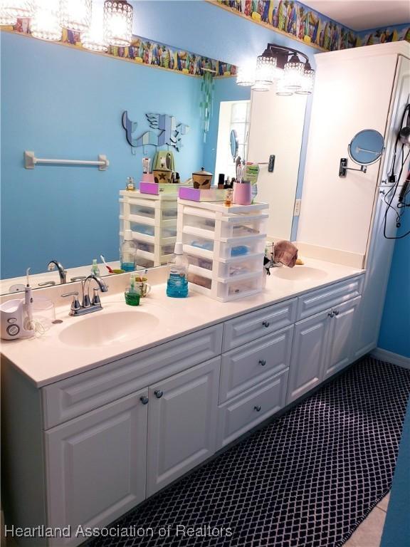 6401 Matanzas Dr, Sebring, FL 33872 - full bathroom with double vanity and tile patterned flooring