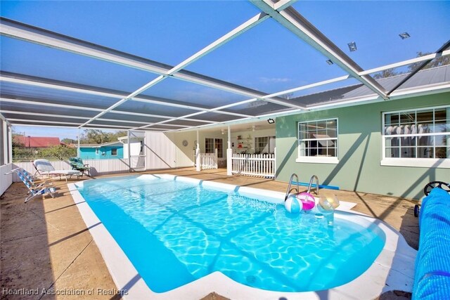 view of swimming pool with a lanai and a patio area