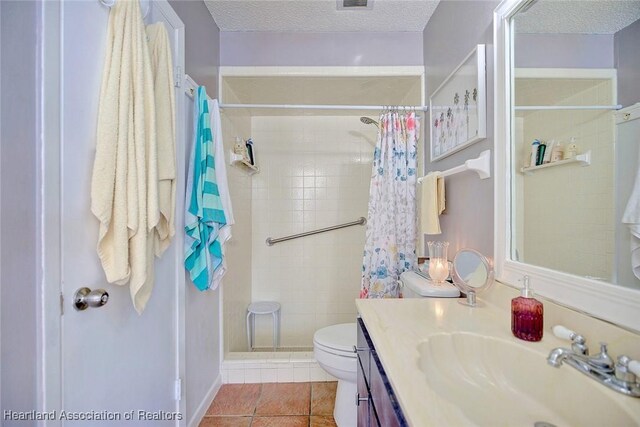 bathroom featuring curtained shower, vanity, a textured ceiling, and toilet