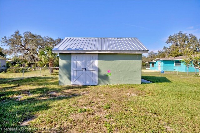 view of outbuilding featuring a yard