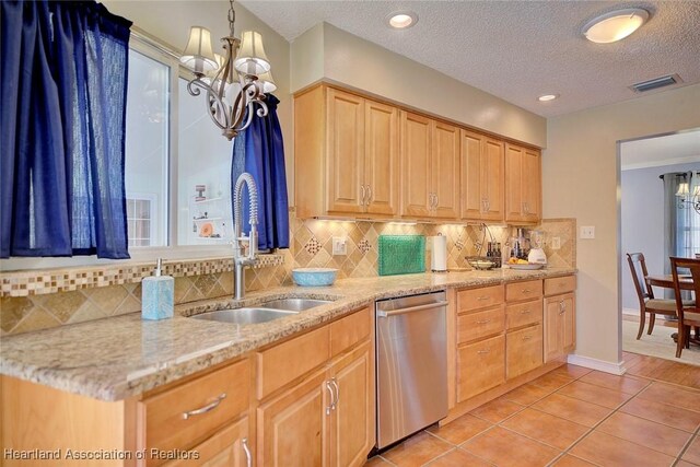 kitchen with backsplash, sink, stainless steel dishwasher, light stone countertops, and light tile patterned floors