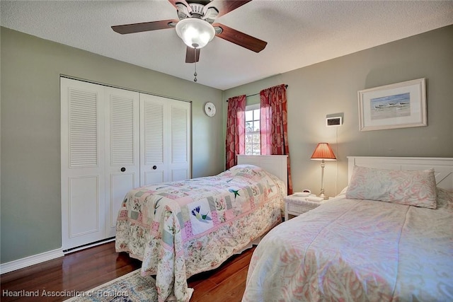 bedroom featuring a textured ceiling, dark hardwood / wood-style flooring, a closet, and ceiling fan