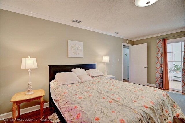 bedroom featuring a textured ceiling, crown molding, and dark hardwood / wood-style floors