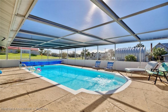 view of swimming pool featuring a lanai and a patio area