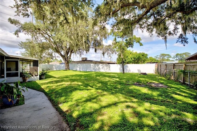 view of yard with a sunroom