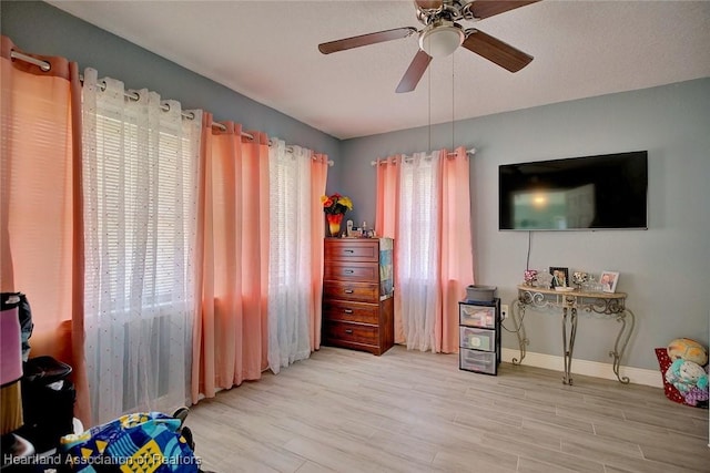 bedroom with ceiling fan and light hardwood / wood-style flooring