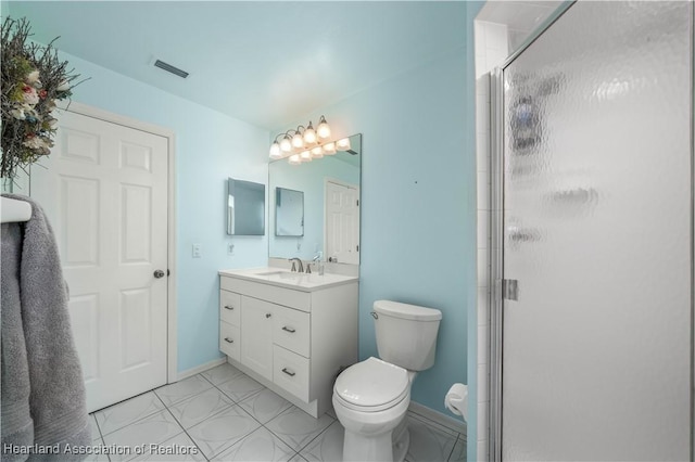 bathroom featuring vanity, toilet, and a shower with door