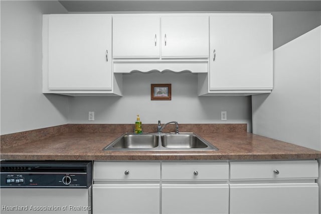 kitchen with white cabinets, dishwasher, and sink