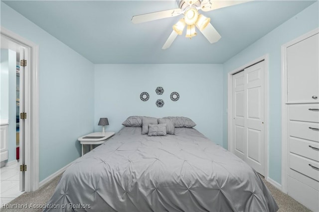 bedroom with a closet, light colored carpet, and ceiling fan