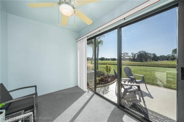 sunroom featuring ceiling fan