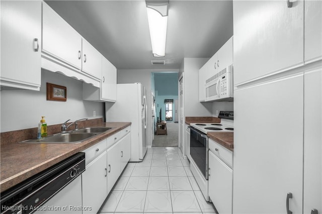 kitchen with sink, white cabinets, and white appliances