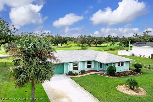 ranch-style house with a garage and a front yard