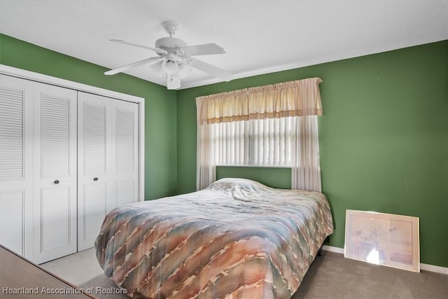 carpeted bedroom featuring a closet and ceiling fan