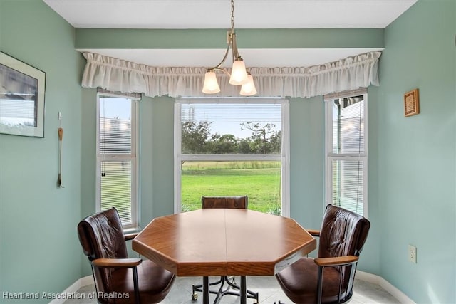 dining area featuring a healthy amount of sunlight and an inviting chandelier