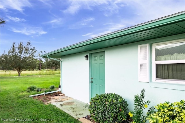 view of outbuilding featuring a lawn