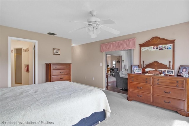 bedroom with ceiling fan and light carpet