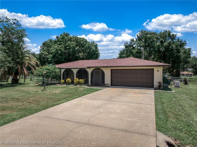 view of front of property with a garage, stucco siding, concrete driveway, and a front yard