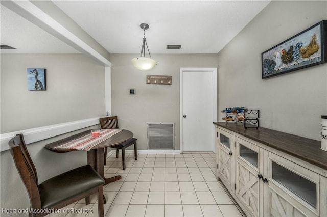 dining space featuring visible vents and light tile patterned flooring