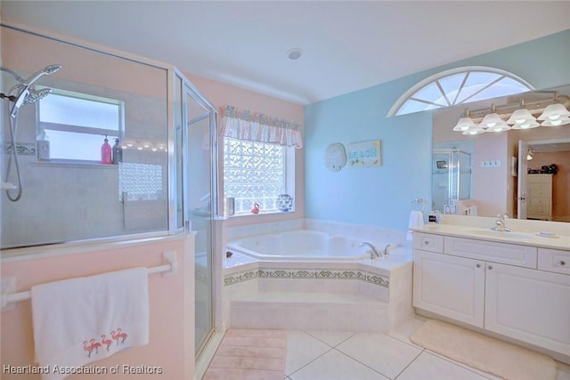 bathroom with vanity, a wealth of natural light, tile patterned floors, and plus walk in shower